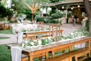 Farm table rentals in Mesa AZ set up for a wedding reception at an outdoor wedding venue.