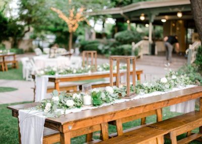 Farm table rentals in Mesa AZ set up for a wedding reception at an outdoor wedding venue.