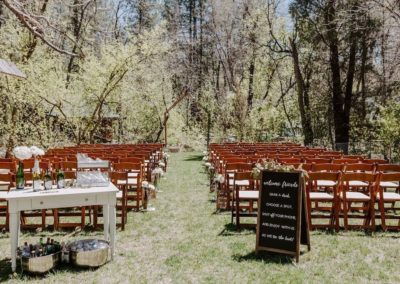Fruitwood folding chair rentals at an outdoor Arizona wedding reception.