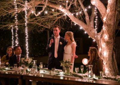 Bride and Groom under lighting at outdoor wedding in Arizona