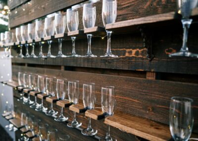 Champagne pallet wall lit up at backyard wedding in Arizona