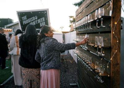 Champagne pallet wall with lights being used at backyard wedding in Arizona