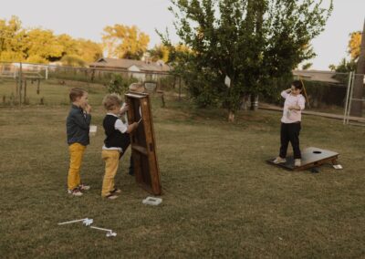 Children playing with two Cornhole boards