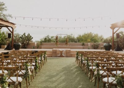 Rows of Wood Cross Back Chairs on each side of an aisle