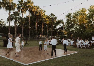 kids dancing on wooden dance floor at outdoor wedding venue