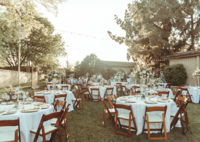 60" Round Tables grouped together, with fruitwood folding chairs placed at each one