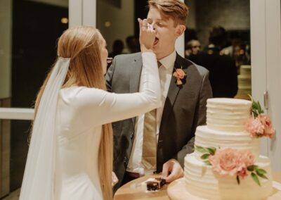 bride and groom sharing a slice of cake