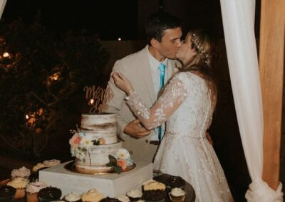 bride and groom standing at a wine barrel table