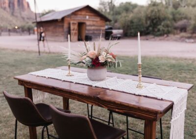 wood table with leather barstools and terracotta pot centerpiece