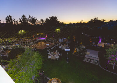 Overhead image of string lights strung above an outdoor wedding reception