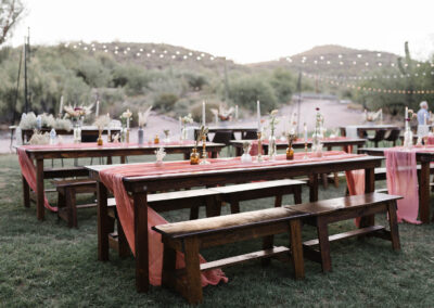 Wood farm table and benches at desert wedding venue