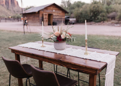 Wood farm table and benches at desert wedding venue